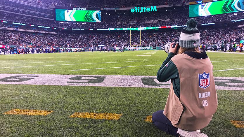 Photo of Gabriella Ricciardi '20 photographing Jets game